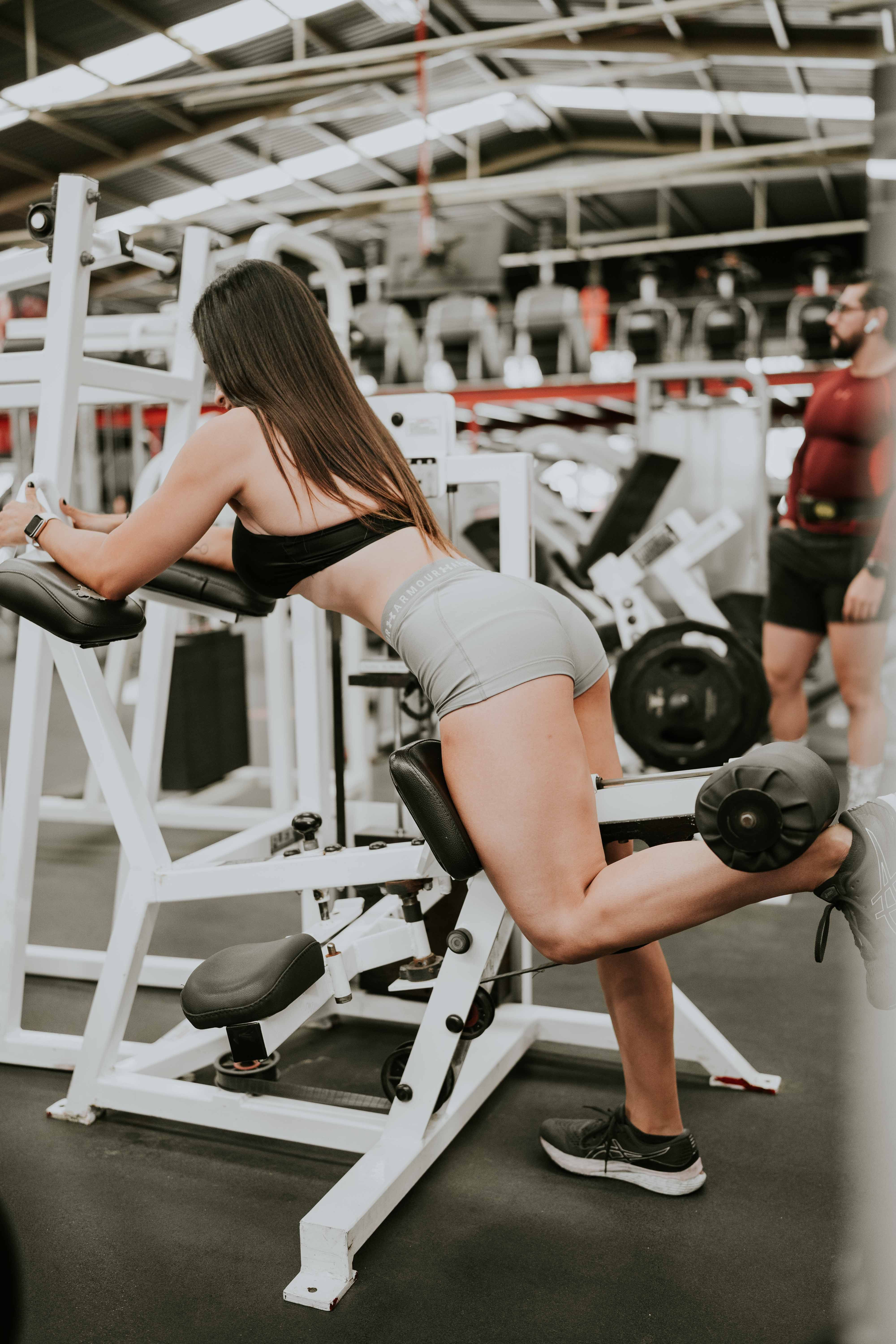 Person performing a leg curl machine exercise for hamstrings